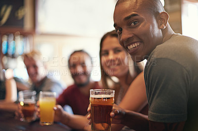 Buy stock photo Portrait of a smiling young man in a bar with some friends