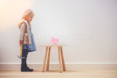 Buy stock photo Finance, piggy bank and a girl with a hammer for savings, money and profit in a house. Investment, ready and a little child standing with a tool to break a cash box for coins, banking or wealth