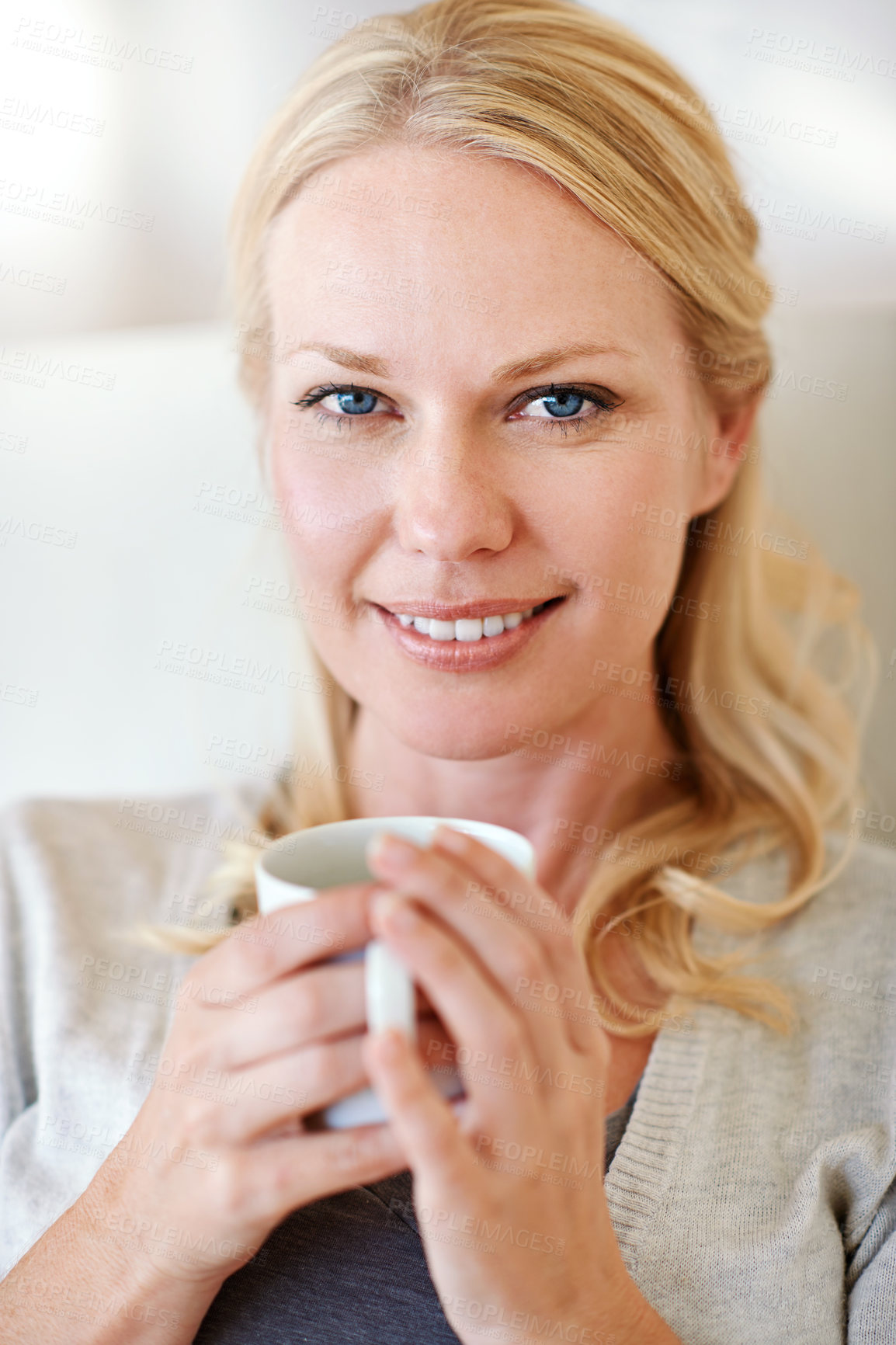 Buy stock photo Portrait of a woman enjoying a cup of coffee at home