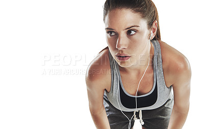 Buy stock photo Cropped shot of a young female athlete listening to music against white background