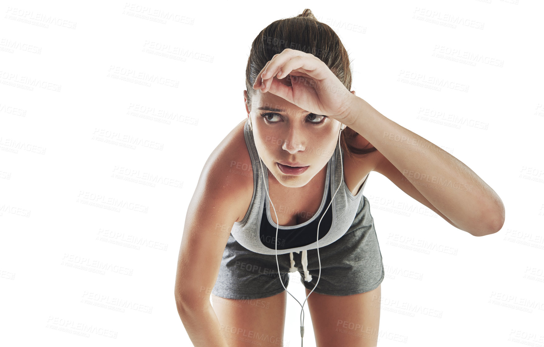 Buy stock photo Cropped shot of a young female athlete listening to music against white background