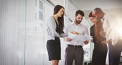 Buy stock photo Shot of businesspeople discussing paperwork in the office