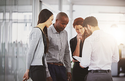 Buy stock photo Shot of businesspeople discussing paperwork in the office