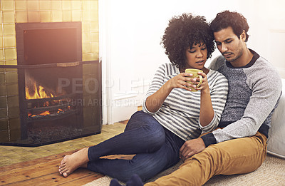 Buy stock photo Couple, fireplace and relax for care and date in home, security and proud of marriage and commitment. People, coffee and bonding on floor in lounge on weekend, support and trust in relationship