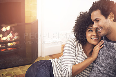Buy stock photo Couple, fireplace and relax in embrace, smile and peace or calm and proud of marriage or commitment. Happy people, holding and hugging on floor in home on weekend, support and trust in relationship