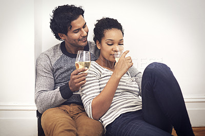 Buy stock photo Couple, floor and wine for celebration and embrace in home, smile and proud of marriage and commitment. People, milestone and drinking in living room on weekend, support and alcohol for relationship