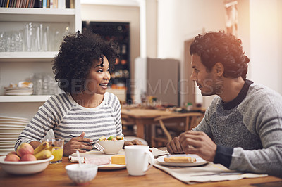 Buy stock photo Breakfast, happy and couple in conversation in kitchen bonding together at apartment. Smile, love and man and woman talking and eating healthy food or meal in morning by dining table at modern home.