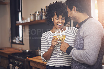 Buy stock photo Couple, kitchen and wine for toast and love in home, smile and proud of marriage and commitment. Happy people, milestone and drinking alcohol on weekend, support and celebration for relationship