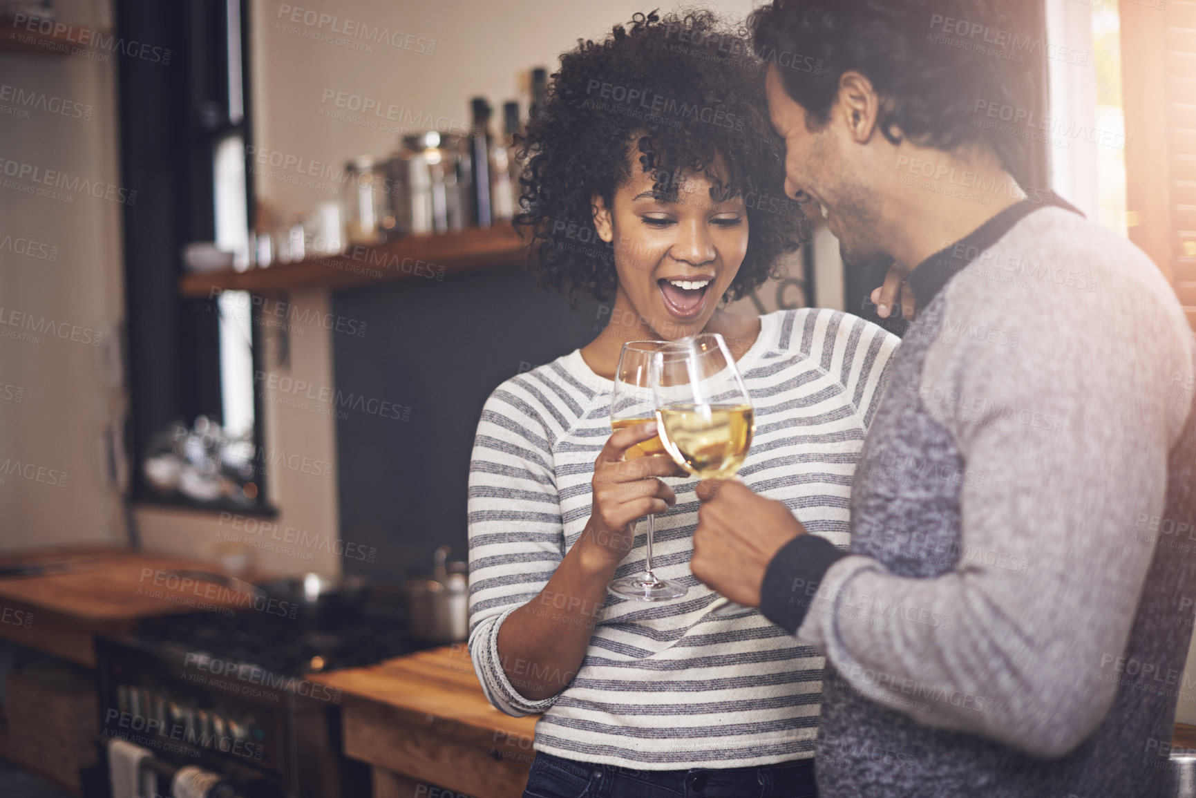 Buy stock photo Couple, kitchen and wine for toast and love in home, smile and proud of marriage and commitment. Happy people, milestone and drinking alcohol on weekend, support and celebration for relationship
