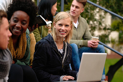 Buy stock photo Woman, university student with laptop and outdoor on campus, smile and research to study for exams. Diverse group, college and information for learning and share notes for test or assignment deadline