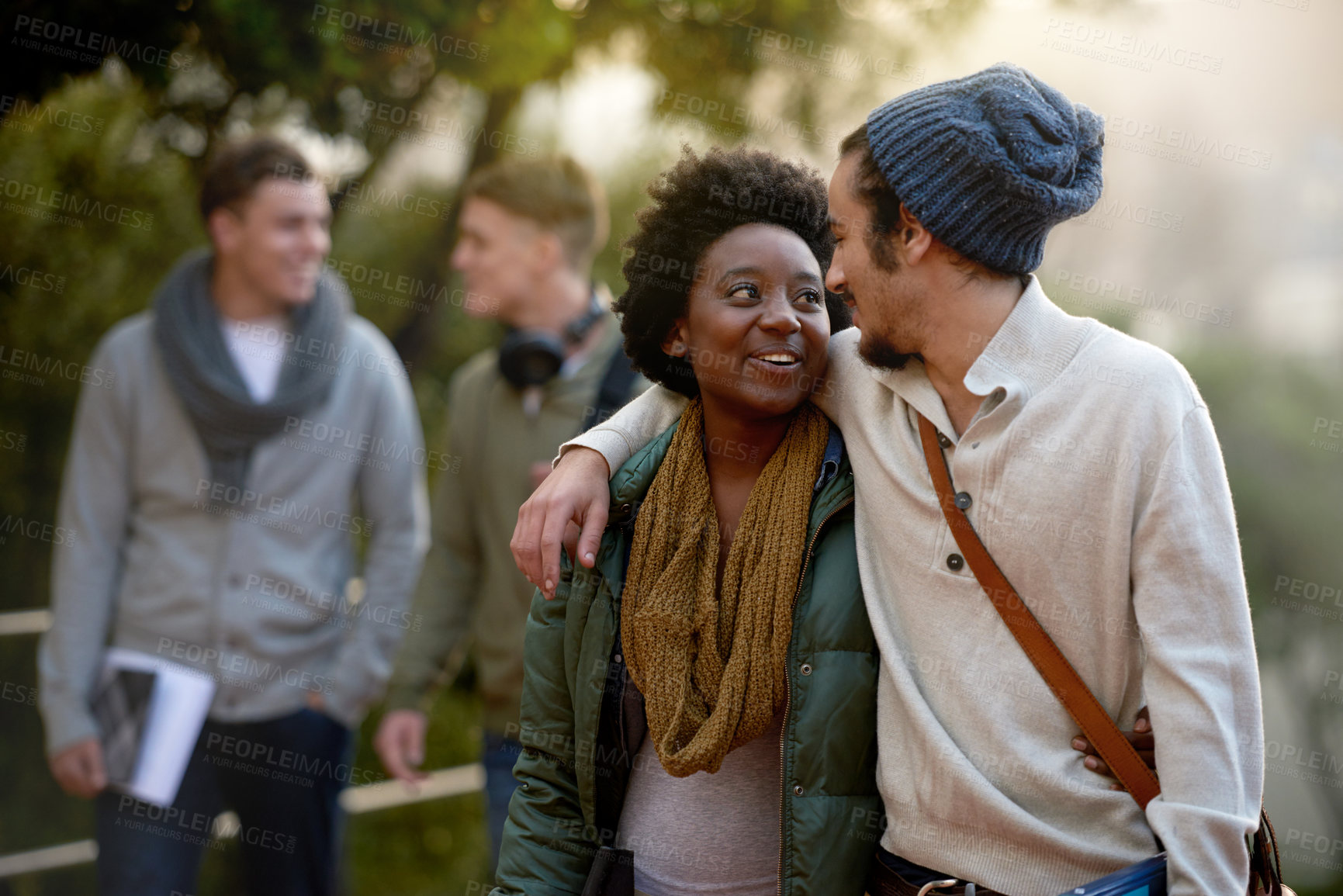 Buy stock photo Students, university and talking of interracial couple of friends on campus with hug and an embrace together. College, school education and diversity with a happy smile ready for class outdoor