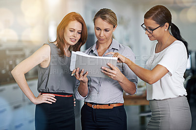 Buy stock photo Cropped shot of a group of female colleagues working together in the office