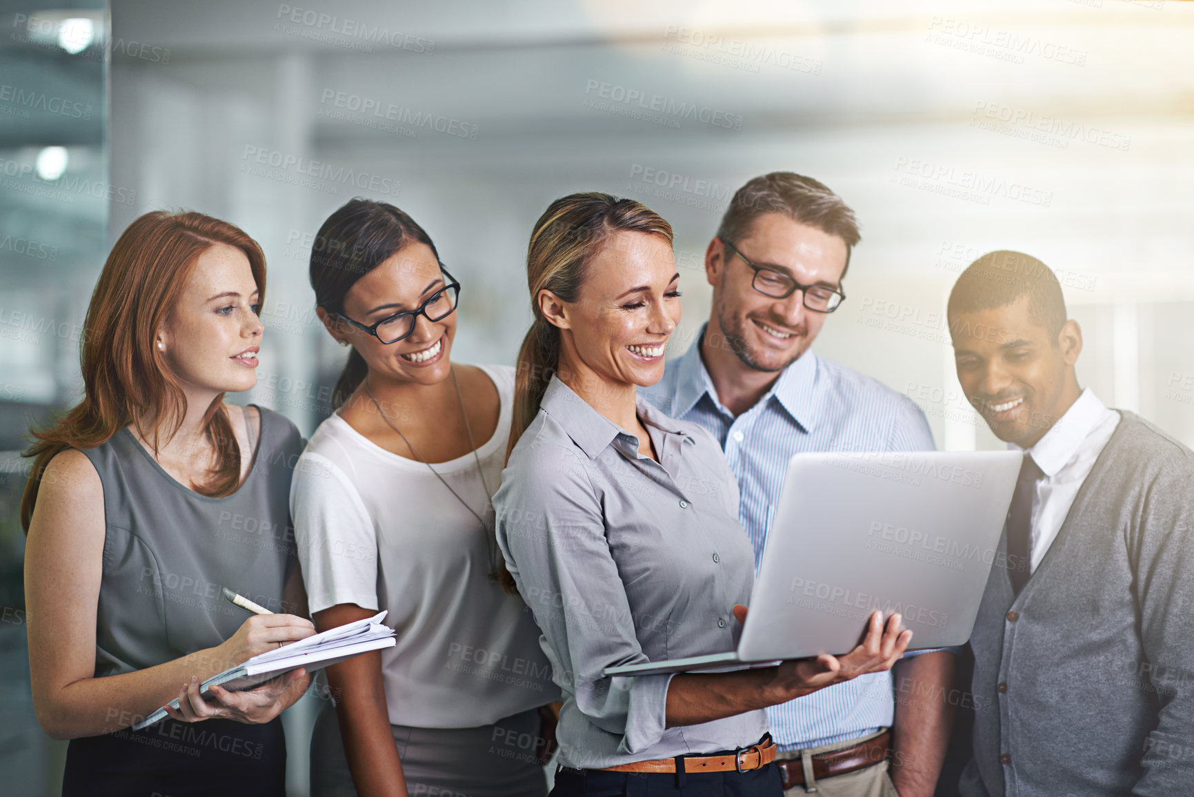 Buy stock photo Shot of a business team working on a laptop together