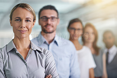 Buy stock photo Portrait of a young businesswoman standing in front of her colleagues