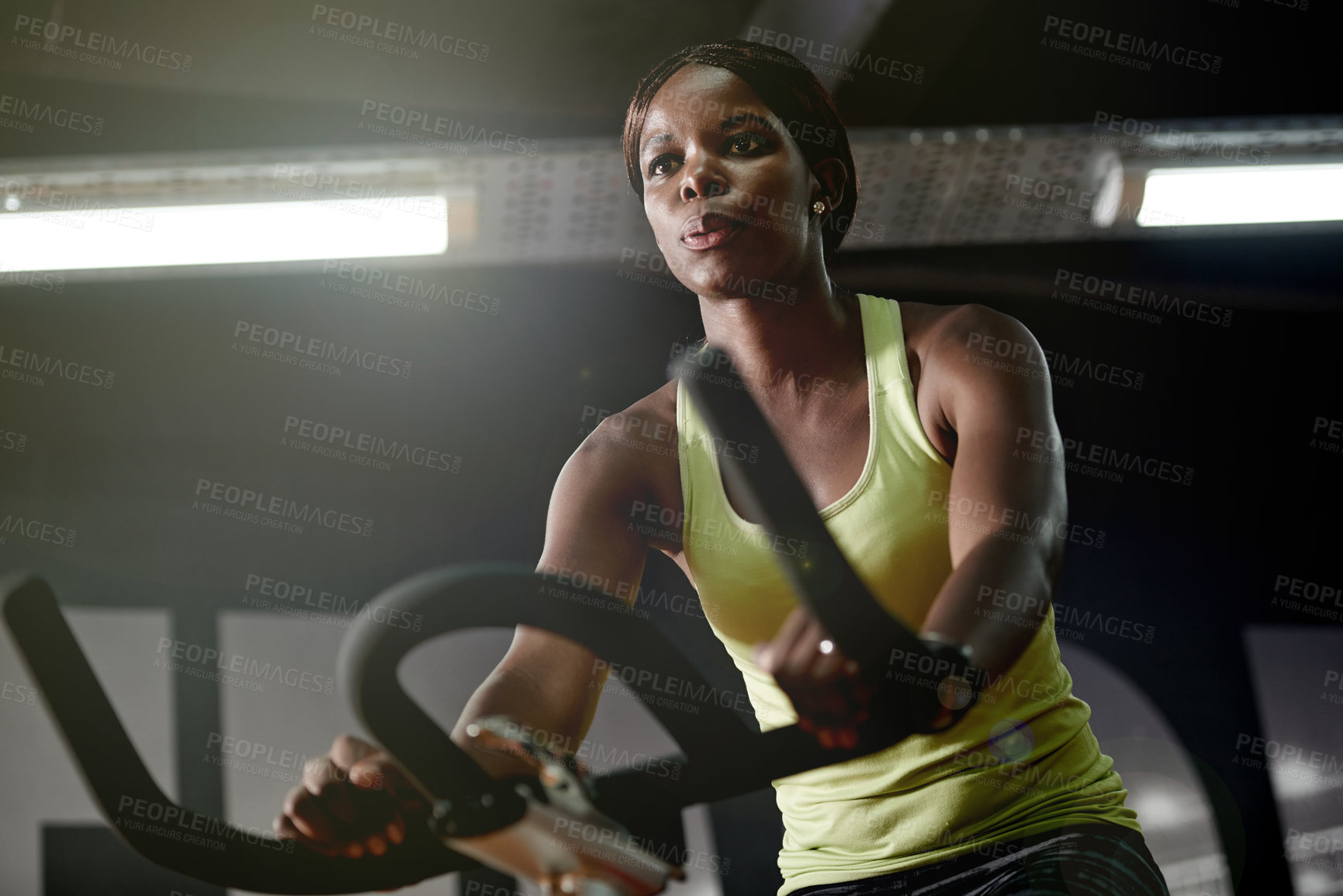 Buy stock photo Cycling, workout or black woman on bike machine for cardio training, exercise or energy for endurance. Development, gym or healthy African sports person in club for fitness, challenge or wellness