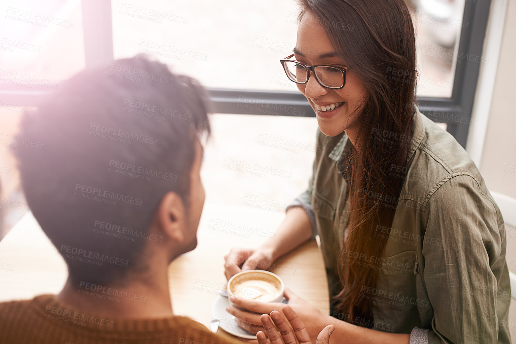 Buy stock photo Couple, date and coffee shop with conversation, smile and talking together with hot drink in a cafe. Woman, social and happy from discussion and chat in a restaurant with tea or cappuccino at table 