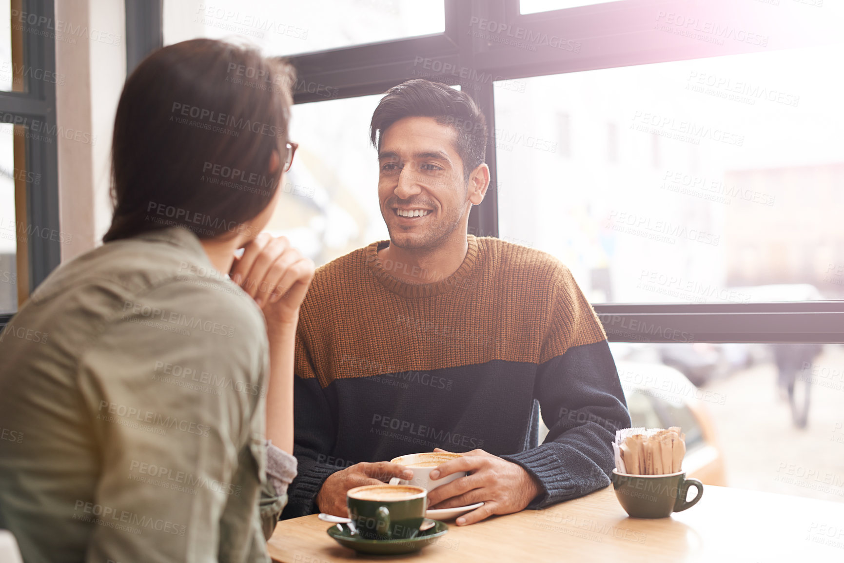 Buy stock photo Coffee shop, happy and couple with drink on date in conversation, talking and chatting for bonding. Love, relax and man and woman with caffeine, cappuccino and beverage in restaurant, cafe and store