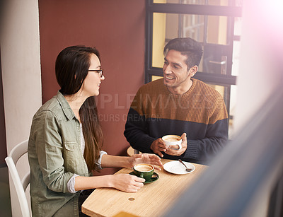 Buy stock photo Coffee shop, morning and couple on date with drink in conversation, talking and chatting for bonding. Love, happy and man and woman with caffeine, cappuccino or beverage in restaurant, cafe and store