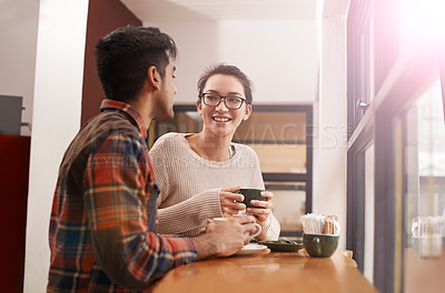 Buy stock photo Couple, date and coffee shop with smile and talking together with hot drink in a cafe. Woman, conversation and happy from discussion and chat in a restaurant with tea or cappuccino at a table 