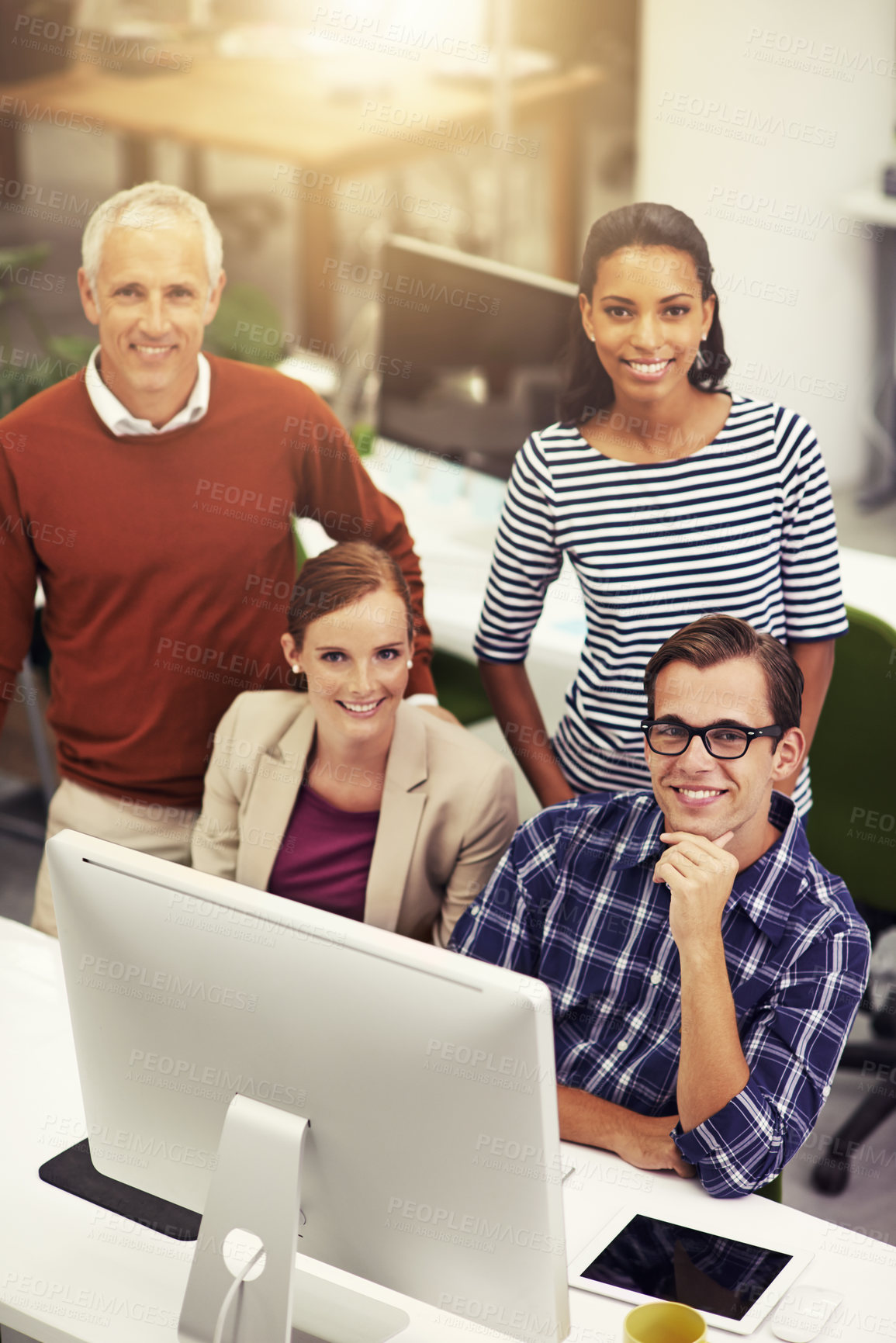 Buy stock photo Diverse group, coworker and smile with computer at office for teamwork, strategy and planning for work. From above, happy and satisfied with collaboration as group for project in startup business.