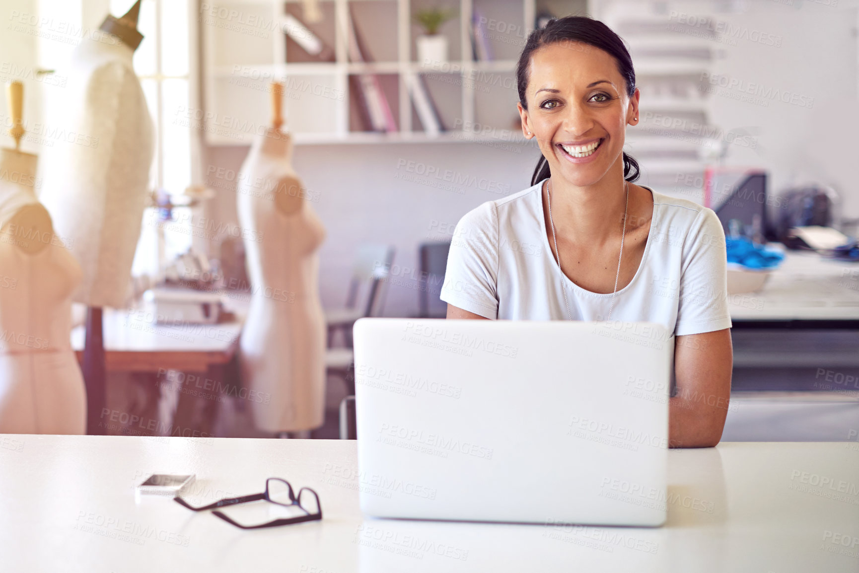 Buy stock photo Portrait of a happy woman working at her desk in a boutique