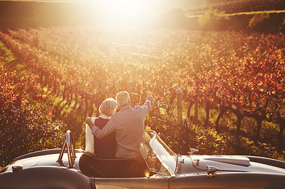 Buy stock photo Romantic, senior couple and vintage car by countryside for wine tasting, sharing drink or memories together on vineyard. Retired man and mature woman on farm visit for celebration, date or roadtrip 