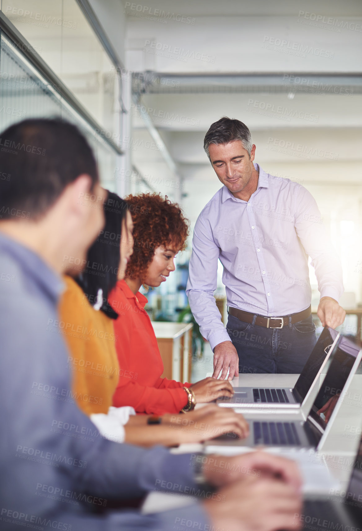 Buy stock photo Cropped shot of a man addressing his employees in the office