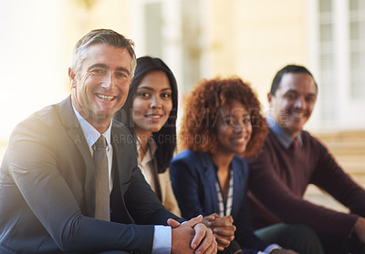Buy stock photo Cropped portrait of a group of coworkers sitting outside
