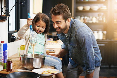 Buy stock photo Cooking, smile and father with daughter in kitchen for pancakes, bonding and learning. Food, morning and helping with man and young girl in family home for baking, support and teaching nutrition