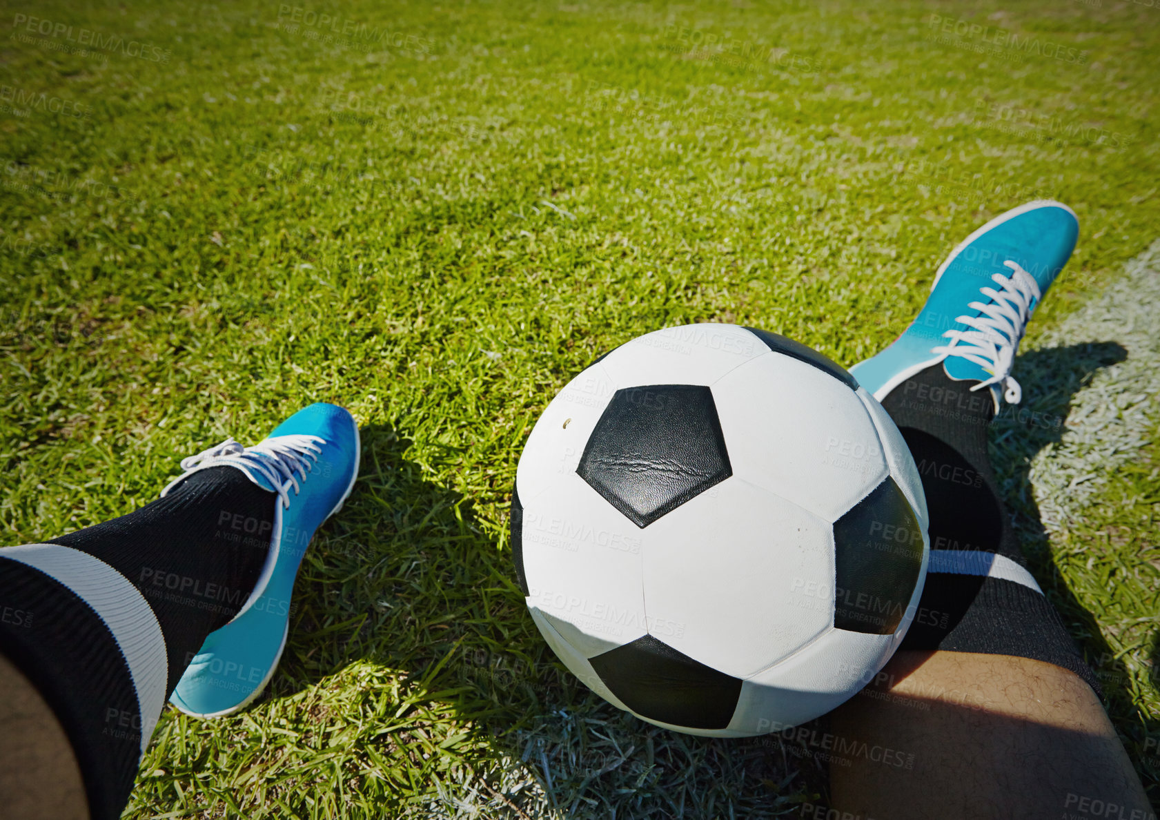 Buy stock photo Sport, field and shoes of man with soccer ball outdoor, relax and resting after fitness or training. Football, pov and male player relaxing on grass at park after workout, match or sports performance