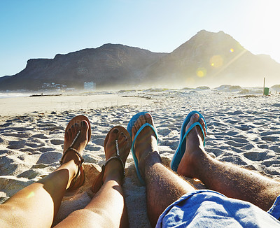 Buy stock photo POV shot of a couple relaxing on the beach