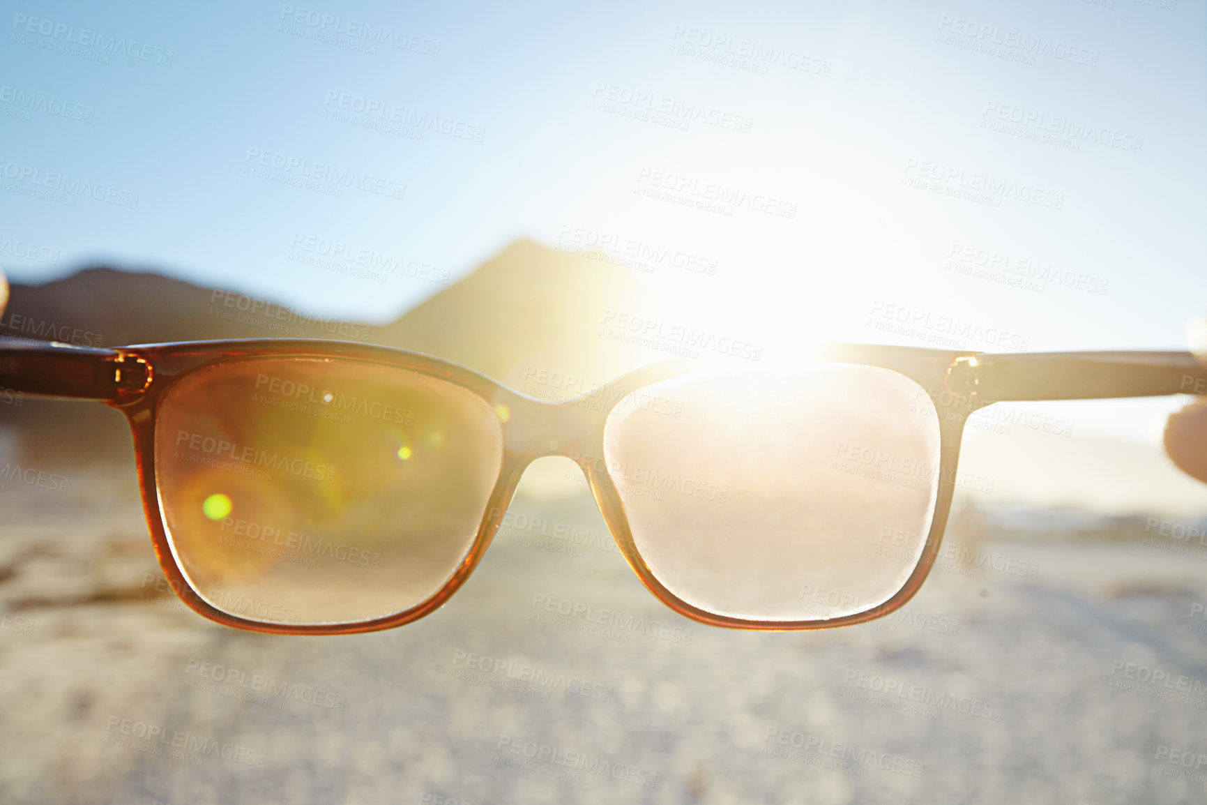 Buy stock photo POV of glasses looking into the sun at the beach. Person holding spectacle toward bright sunlight or sunshine at the sea shore. Eyewear protecting eyesight from the light outdoors at the ocean