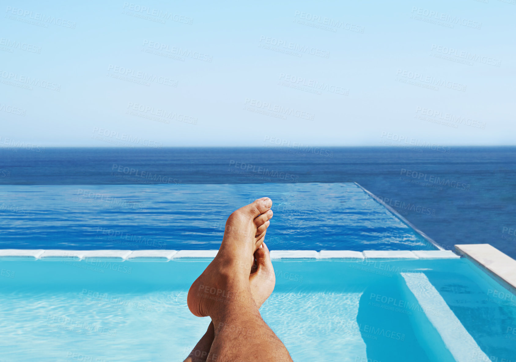 Buy stock photo POV, feet and man relax at a pool for travel and summer vacation at the sea by hotel and water. Barefoot, calm and traveling person outdoor at poolside holiday or rest at luxury resort in Maldives 