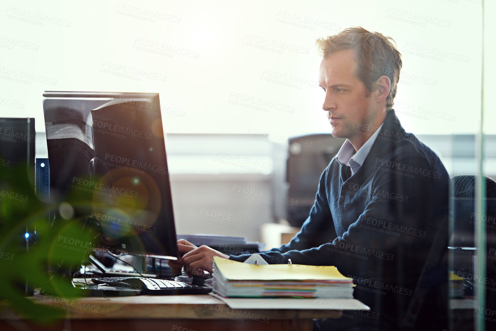 Buy stock photo Cropped shot of a businessman working at his desk