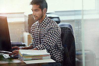 Buy stock photo Cropped shot of a businessman working at his desk