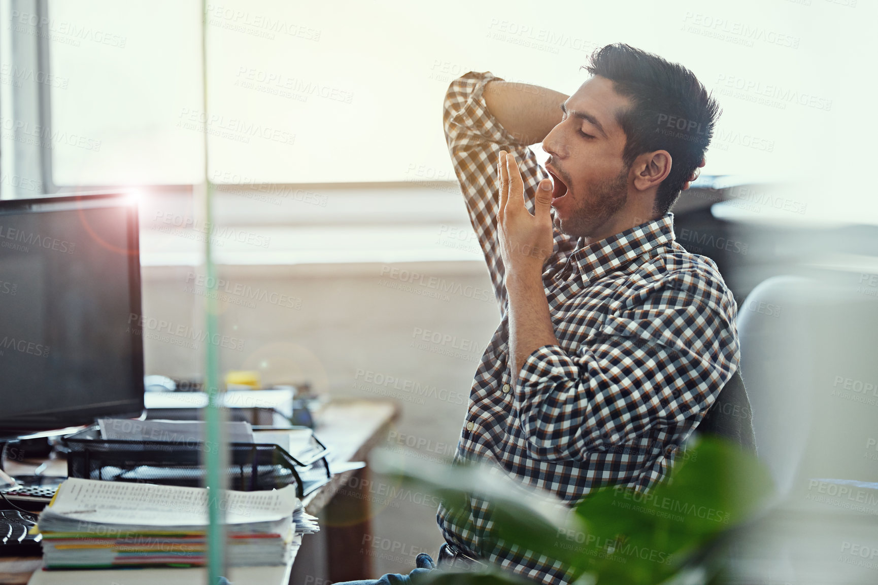 Buy stock photo Cropped shot of a businessman yawning while working at his desk