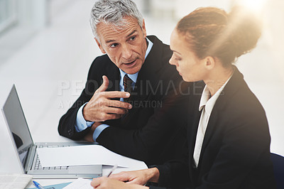 Buy stock photo Boss, laptop and meeting with employee in office with brainstorming in corporate company. Woman, serious and listening to CEO of business, professional and notebook for planning on desk in workplace