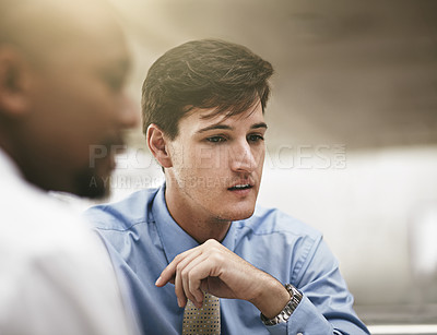 Buy stock photo Cropped shot of two businessmen discussing work in the office