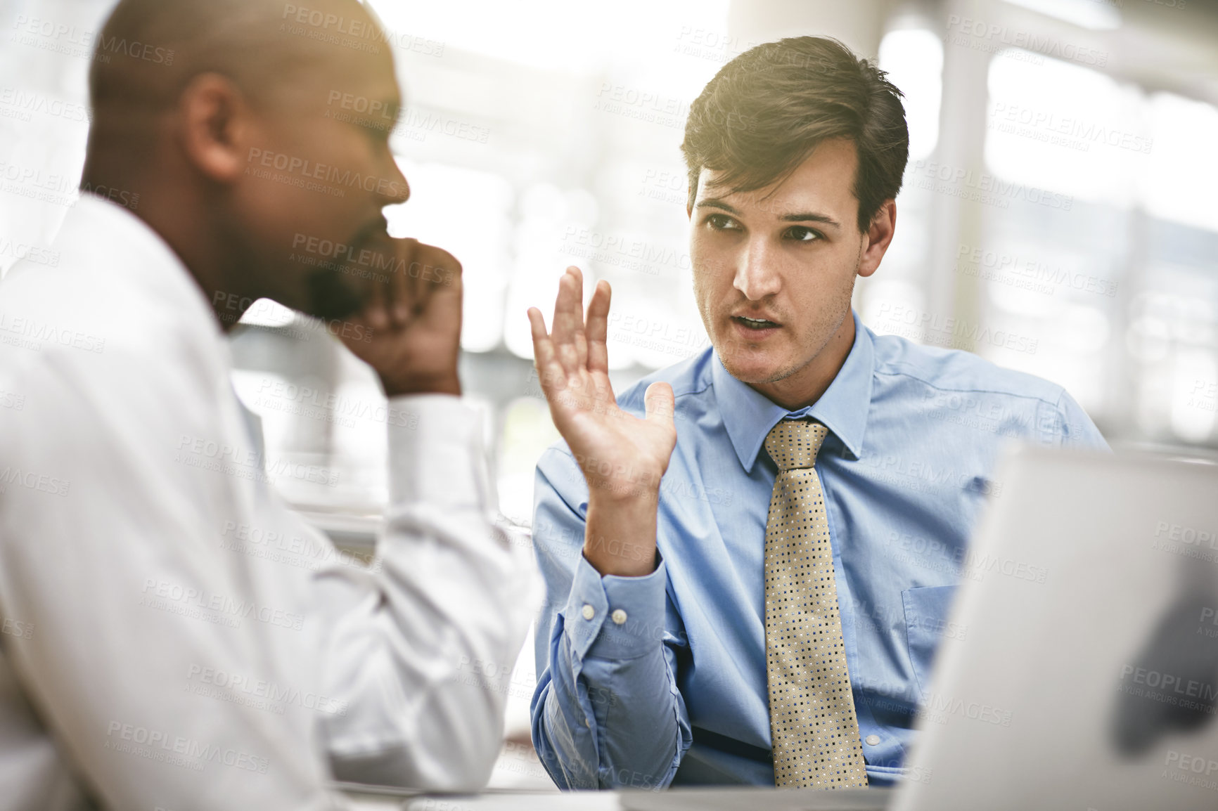 Buy stock photo Cropped shot of two businessmen discussing work in the office