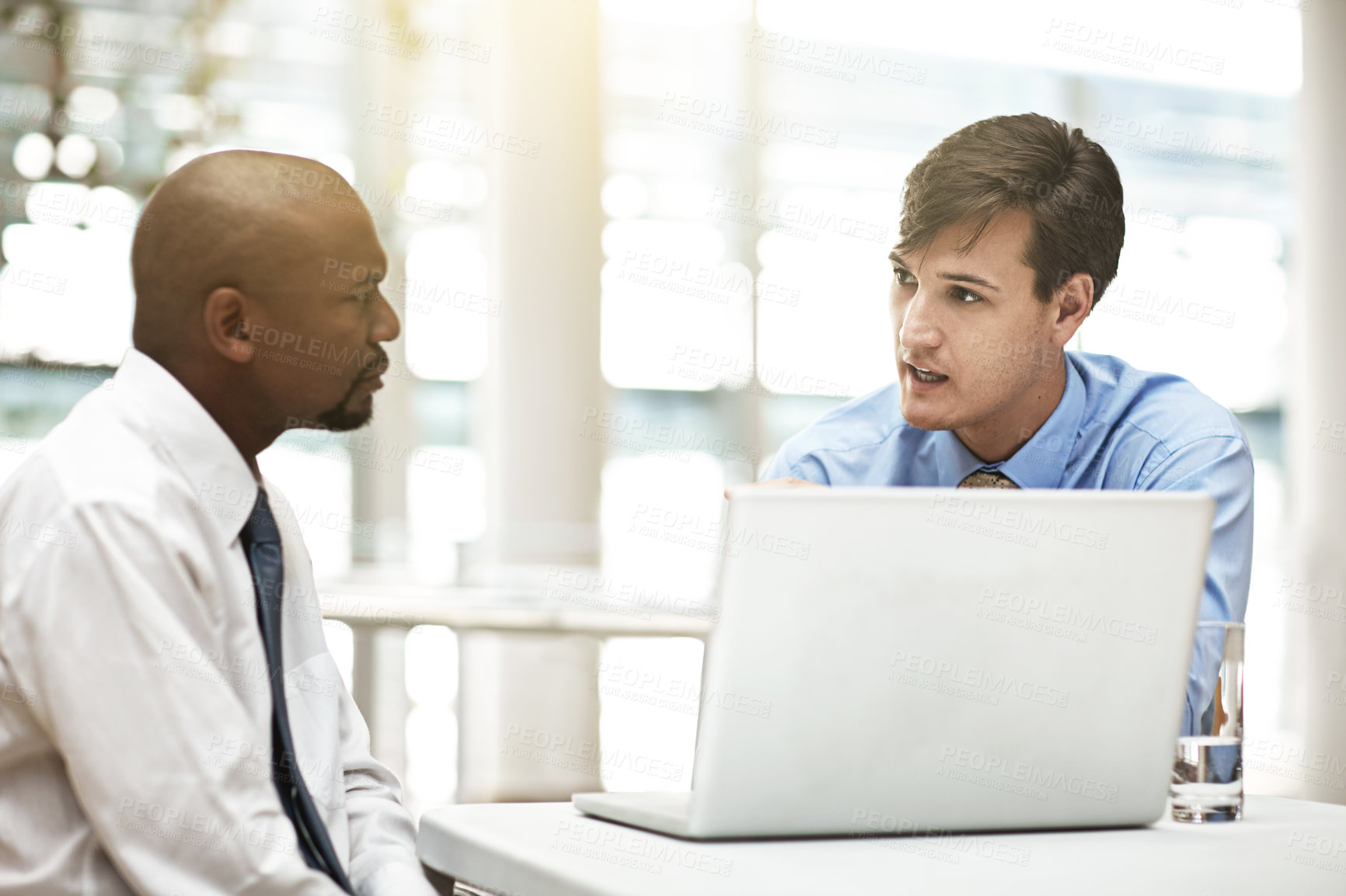 Buy stock photo Cropped shot of two businessmen discussing work in the office