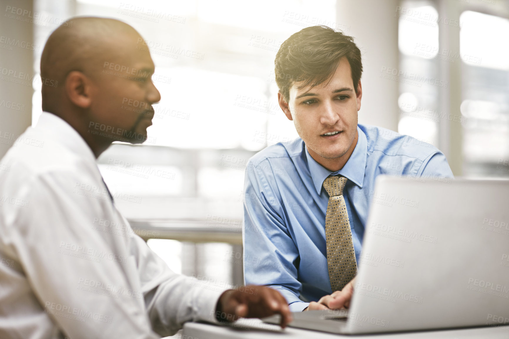 Buy stock photo Cropped shot of two businessmen discussing work in the office