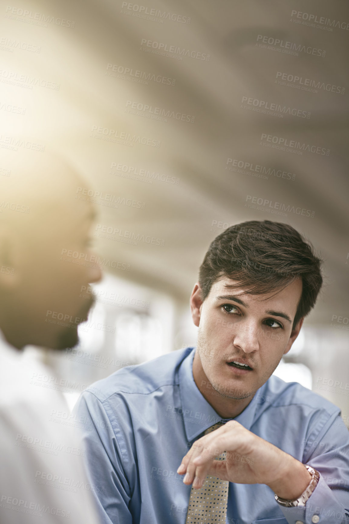 Buy stock photo Cropped shot of two businessmen discussing work in the office