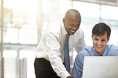 Buy stock photo Cropped shot of two businessmen discussing work in the office