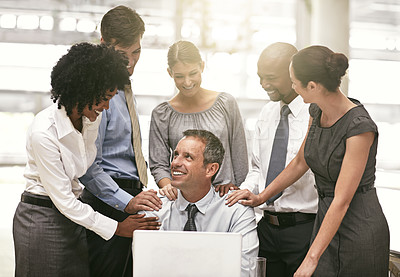Buy stock photo Laptop, collaboration and achievement with a business team  congratulating a male colleague in the office. Computer, proud or motivation with a group of colleagues working together to achieve success