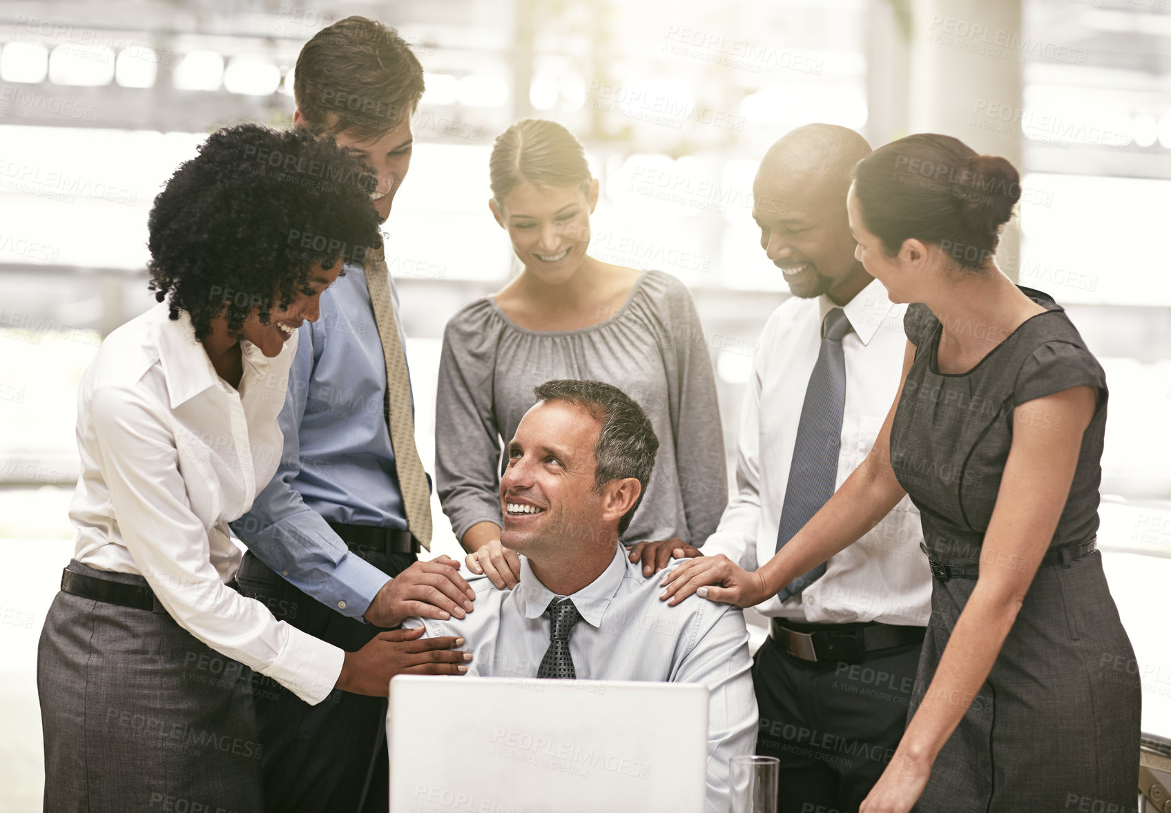 Buy stock photo Laptop, collaboration and achievement with a business team  congratulating a male colleague in the office. Computer, proud or motivation with a group of colleagues working together to achieve success