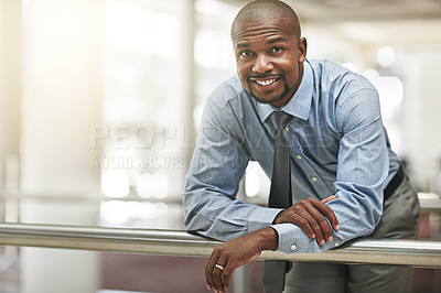 Buy stock photo Cropped portrait of a businessman leaning against a railing in the office hallway
