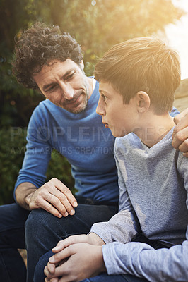 Buy stock photo Family, father and son have conversation in backyard, bonding with love and care, communication and relationship. Man help by giving teen boy advice at home, outdoor together with trust and support