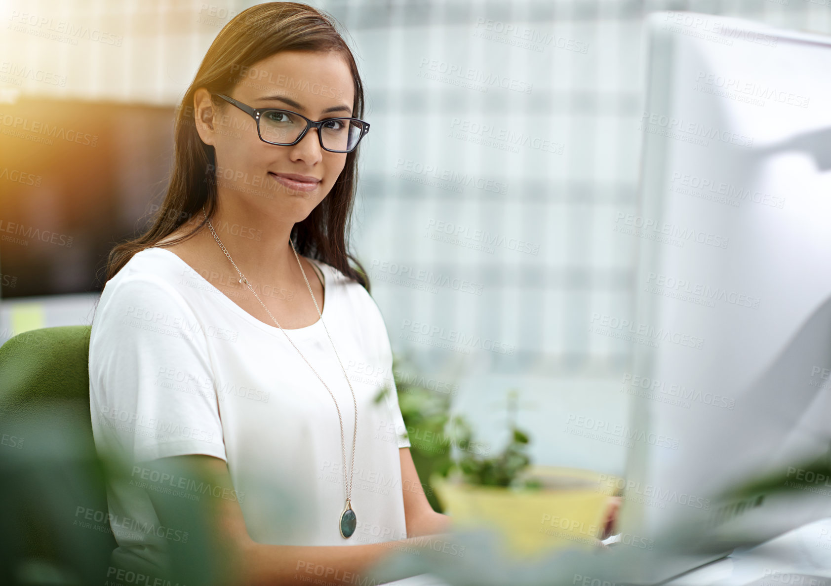 Buy stock photo Cropped portrait of a young businesswoman working at her desk