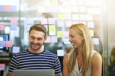 Buy stock photo Cropped shot of two business colleagues working on their project