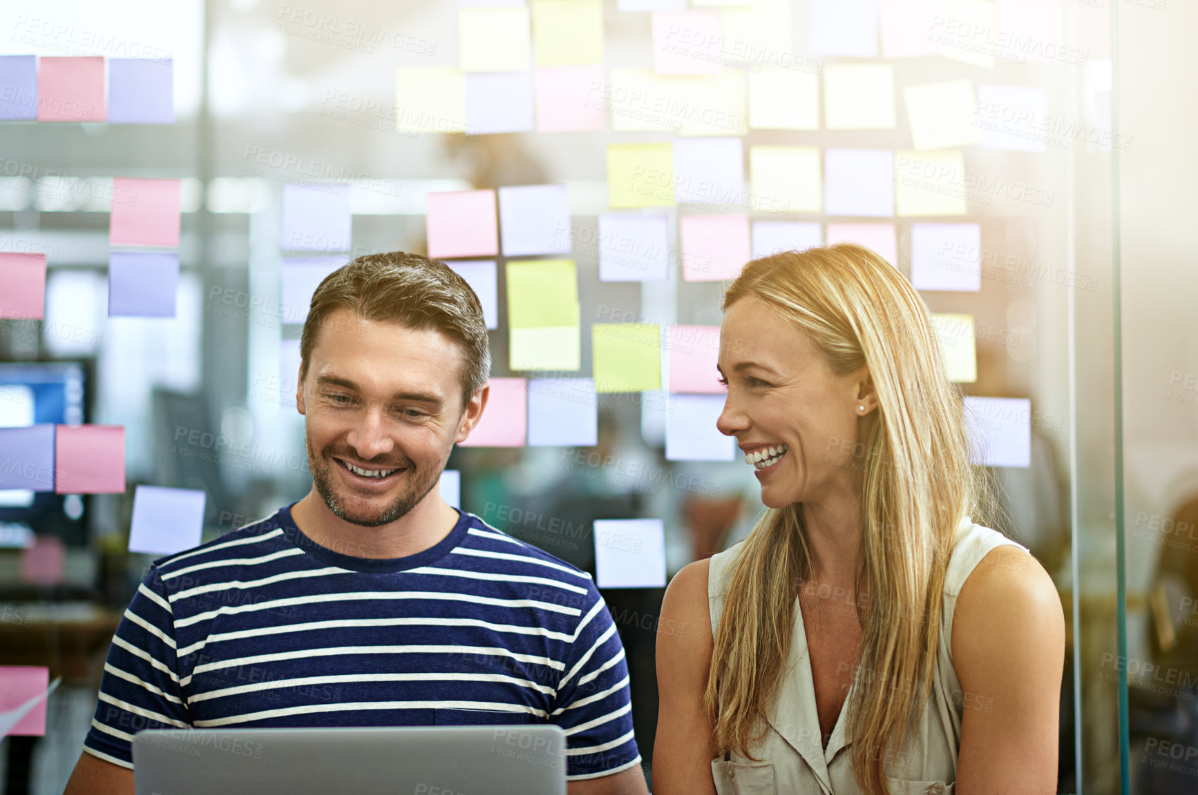 Buy stock photo Cropped shot of two business colleagues working on their project